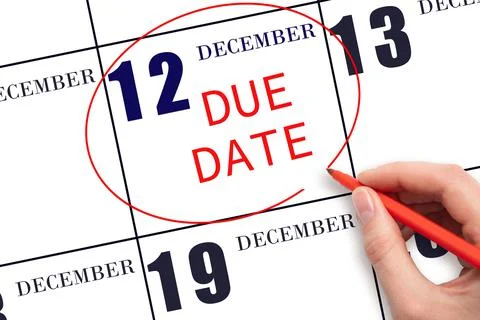 Hand writing text DUE DATE on calendar date December 12 and circling it. Paym Stock Photos