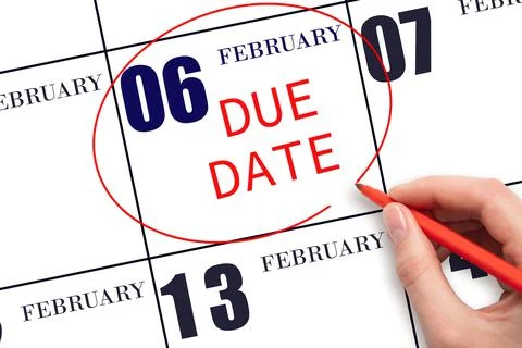 Hand writing text DUE DATE on calendar date February 6 and circling it. Payme Stock Photos