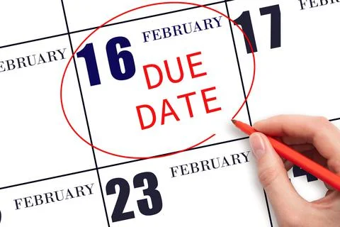 Hand writing text DUE DATE on calendar date February 16 and circling it. Paym Stock Photos