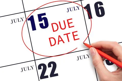 Hand writing text DUE DATE on calendar date July 15 and circling it. Payment  Stock Photos