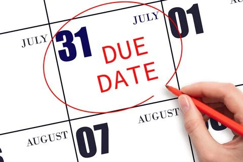 Hand writing text DUE DATE on calendar date July 31 and circling it. Payment  Stock Photos