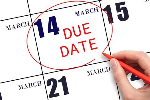 Hand writing text DUE DATE on calendar date March 14 and circling it. Payment Stock Photos