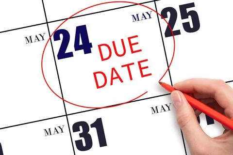 Hand writing text DUE DATE on calendar date May 24 and circling it. Payment d Stock Photos
