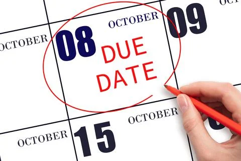 Hand writing text DUE DATE on calendar date October 8 and circling it. Paymen Stock Photos