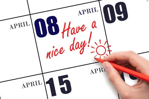 The hand writing the text Have a nice day and drawing the sun on the calendar Stock Photos