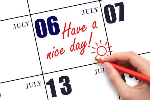 The hand writing the text Have a nice day and drawing the sun on the calendar Stock Photos