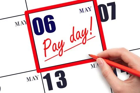 Hand writing text PAY DATE on calendar date May 6 and underline it. Payment.. Stock Photos