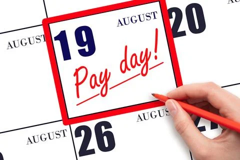 Hand writing text PAY DATE on calendar date August 19 and underline it. Pay.. Stock Photos