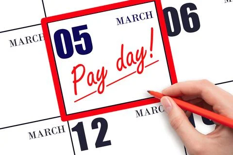 Hand writing text PAY DATE on calendar date March 5 and underline it. Payme.. Stock Photos