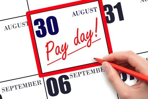 Hand writing text PAY DATE on calendar date August 30 and underline it. Pay.. Stock Photos