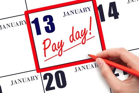 Hand writing text PAY DATE on calendar date January 13 and underline it. Pa.. Stock Photos