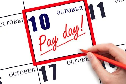 Hand writing text PAY DATE on calendar date October 10 and underline it. Pa.. Stock Photos