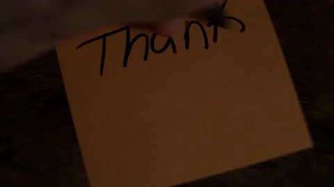Hand writing a thank you note with a smiley face Stock Footage 319344217