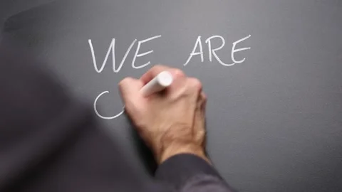 Hand writing We are open on chalkboard and highlighting Stock Footage 146393651