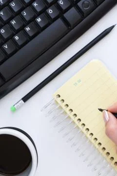 Hand writing on white background overhead view Stock Photos