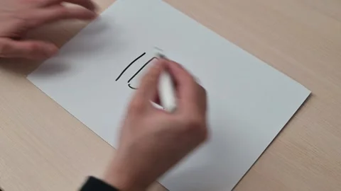 A hand is writing the word Idea on a blank sheet of paper. The process includes Stockbeeldmateriaal 337550489