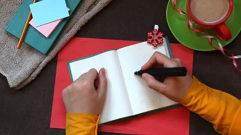 Hand writing word Soon in notebook, top view Stock Footage 70391628