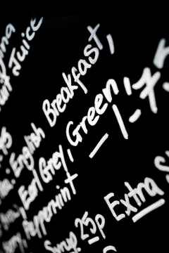 Hand written chalk menu board featured the word Breakfast prominently Stock Photos