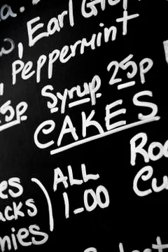 Hand written chalk menu board featured the word Cakes prominently Stock Photos