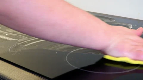 Hand in yellow cloth wipes ceramic surface Stock Footage 59057495