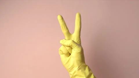Hand in yellow rubber glove showing number one 1, two 2, three 3, four 4, five 5 Stock Footage