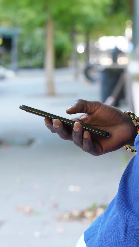 Hand of young Black man using smartphone on street Stock Footage 287135646