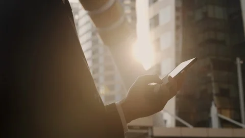 Hand of young businessman standing using a smartphone Stock Footage 120823677
