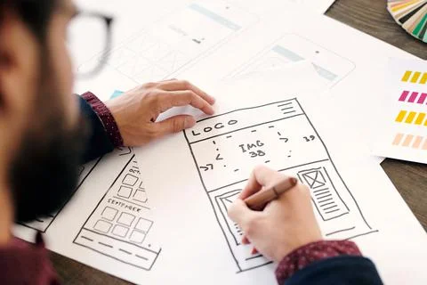 Hand of young contemporary developer of mobile application drawing sketch Stock Photos