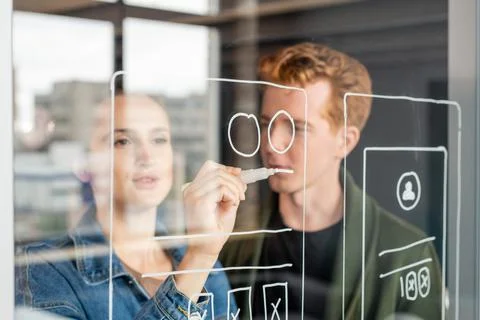 Hand of young female software developer drawing sketch of mobile application 스톡 사진