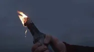 Hand Of Young Man With A Burning Molotov Cocktail In Hand Standing On Coast Stock Footage
