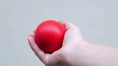 Hand of young man does rehabilitation exercises squeezing rubber ball Stock Footage 240328662