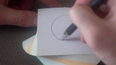 The hand of the young man draws a sad face,then crossed out,tears off the page Stock-Footage 75912980