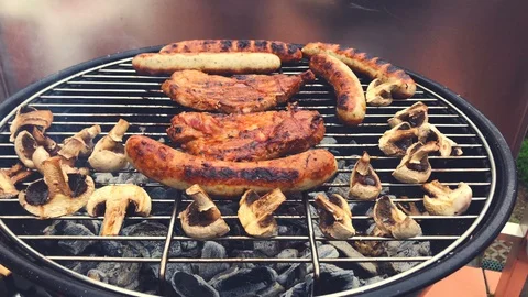 Hand of young man grilling some steak, sausage on grill Stock Footage 107832507