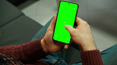 Hand of young man holding smartphone green screen in business office work Stock Footage 336068008