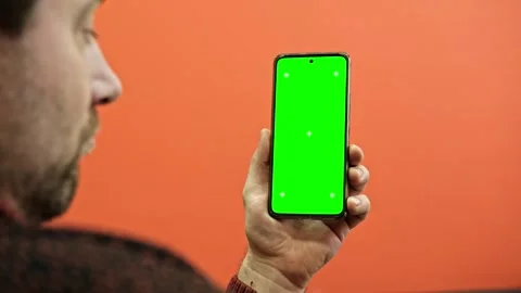 Hand of young man holding smartphone green screen in business office work Stock Footage 336069872