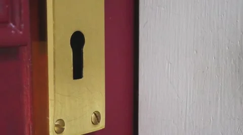 Hand of young man locks a door with a key Video stock 67475747