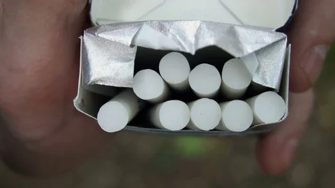 The hand of the young man pulls out a cigarette from the pack,slow motion Stock Footage 77149497