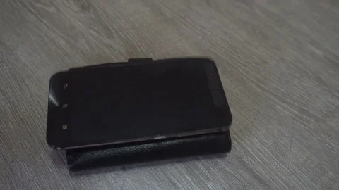 The hand of the young man puts on the table a wallet,smartphone and keys,concept Stock Footage 83626219