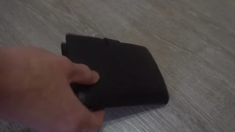 The hand of the young man puts on the table a wallet,smartphone and keys,concept Stock Footage 83627438