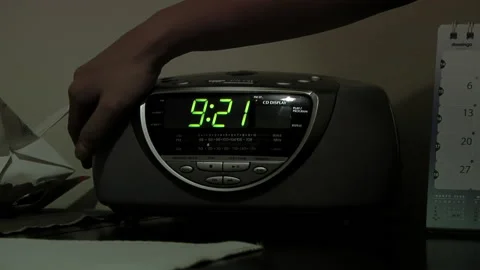 Hand of a Young Man Setting on Alarm Clock. Close Up. Stock Footage