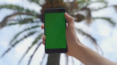 Hand of young man smartphone viewing green screen on mobile phone browsing Stock Footage 134383642