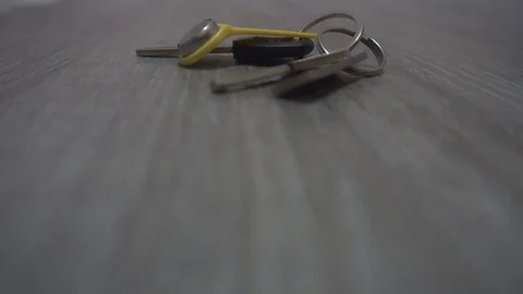 The hand of the young man takes the keys from the table,the concept of leaving Stock Footage 83629418