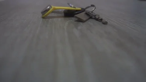The hand of the young man takes the keys from the table,the concept of leaving Stock Footage 83629619