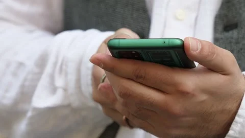 Hand of young man types on mobile phone keyboard Stock Footage 240395881