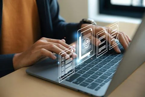 Hand of young man using laptop with document and mark correct sign. Stock Photos