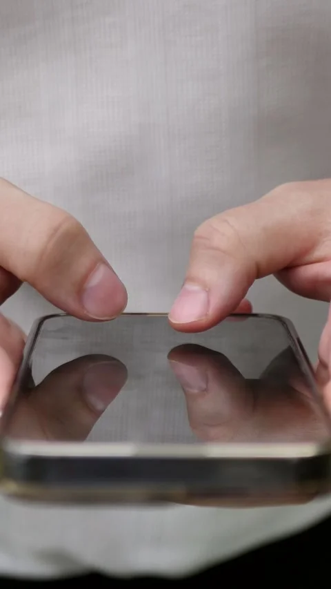 Hand of young man using mobile phone, writing message and browsing news online Stock-Footage 303690902