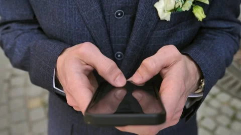 Hand of young man using mobile phone, writing message and browsing news online Stock Footage 309322053