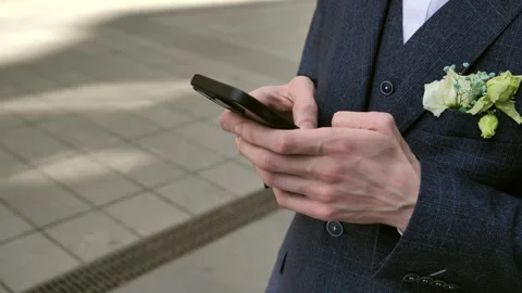 Hand of young man using mobile phone, writing message and browsing internet Stock Footage 309322149