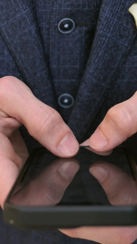 Hand of young man using mobile phone, writing message and browsing news online Stock Footage 309322609