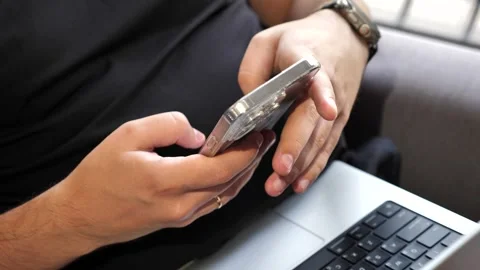 Hand of young man using mobile phone, writing message and browsing internet Stock Footage 316766518